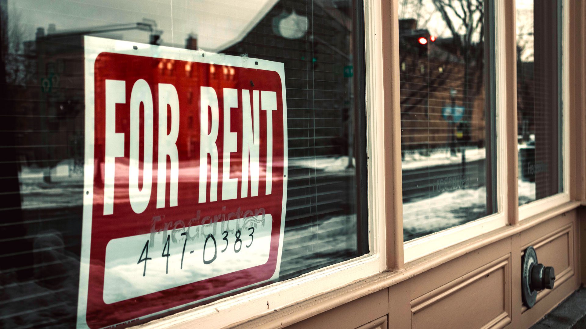 stock photo of a for rent sign in a window